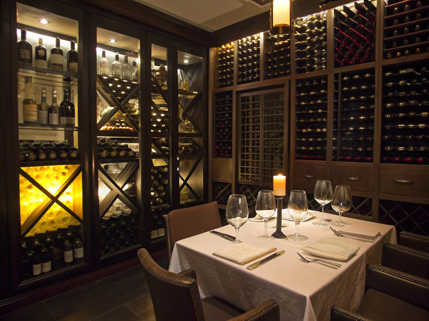 Vaulted private wine cellar dining room with soft candlelit ambiance